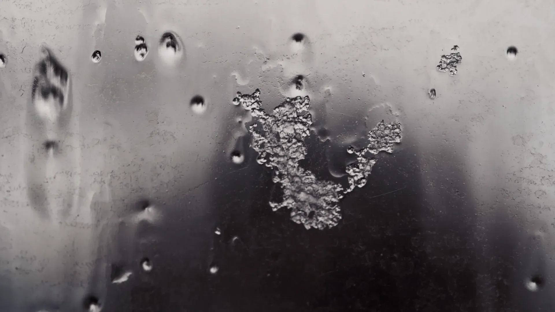 Melting ice on a dark surface, a still from the hero video